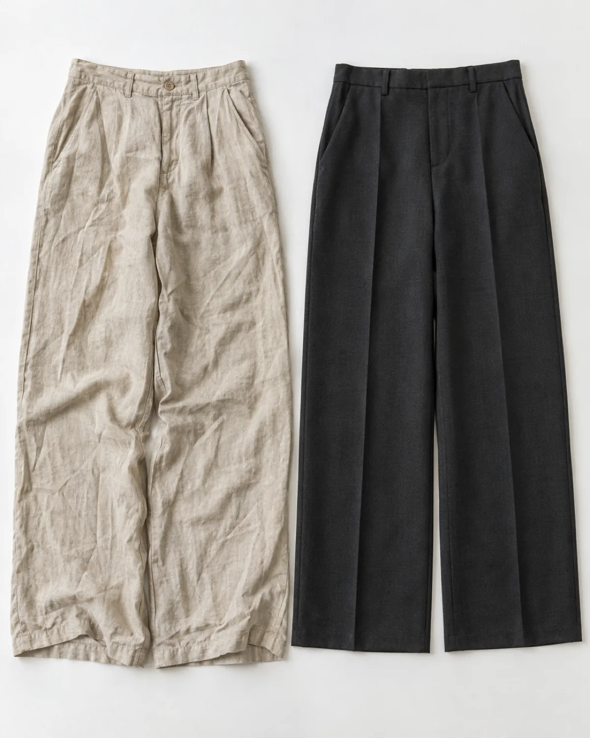 Overhead flat-lay on a white surface showing two pairs of wide-leg trousers side by side, wrinkled beige linen on the left and neatly pressed charcoal wool crepe with a crisp front crease on the right